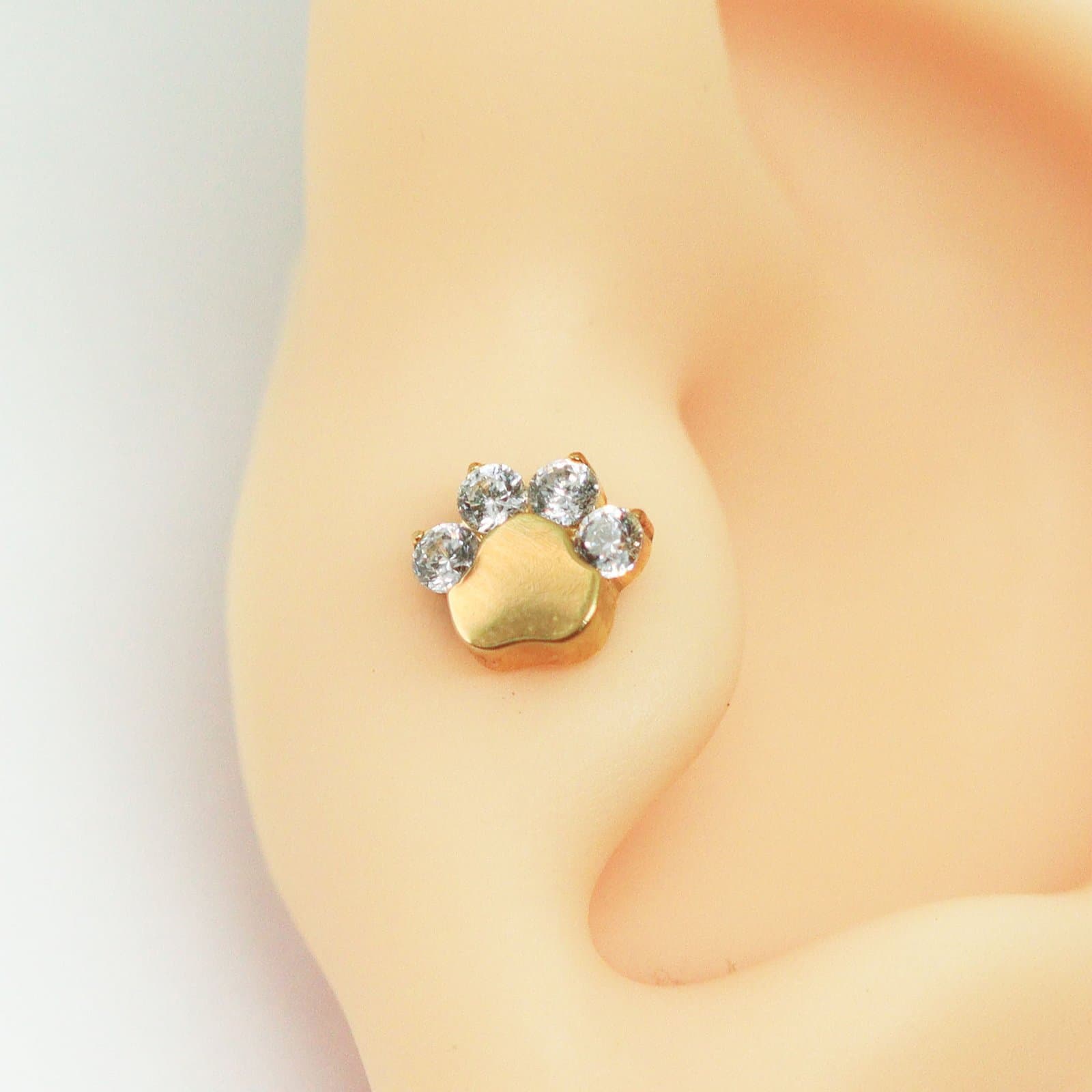 Piercing Trágus Labret de Patinha Cravejado em Titânio PVD Gold